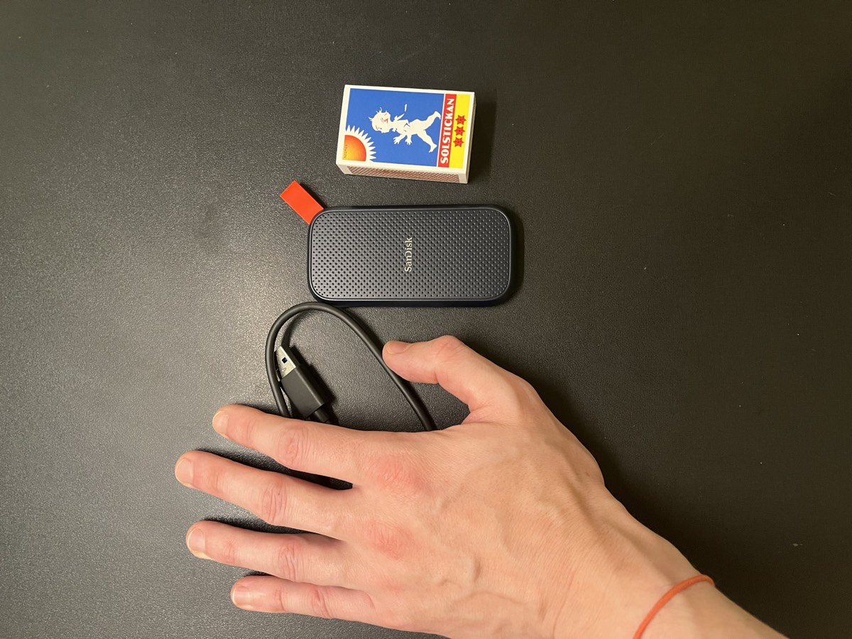 SanDisk Portable SSD size compared to hand and matchbox